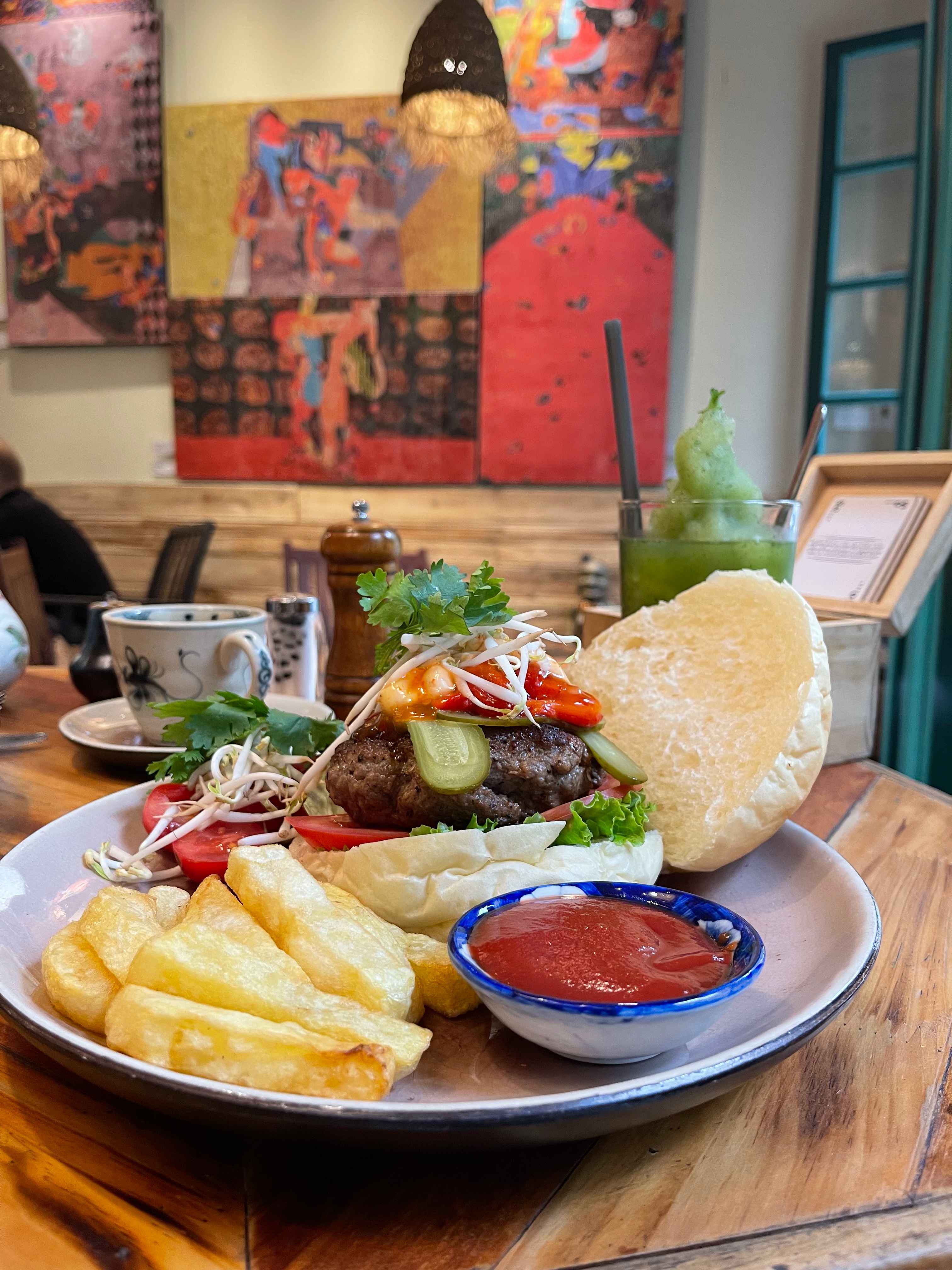 Social Club Burger served against art-covered walls