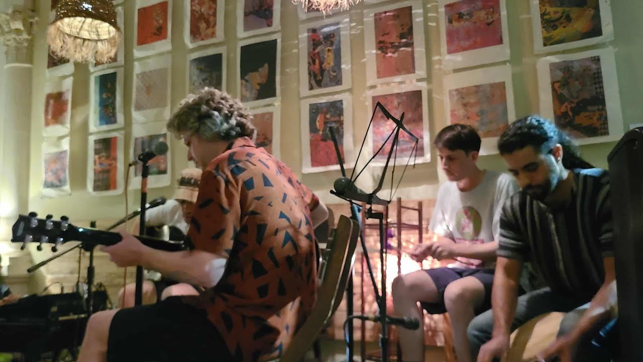 Phantom Boss performing live against art-covered walls