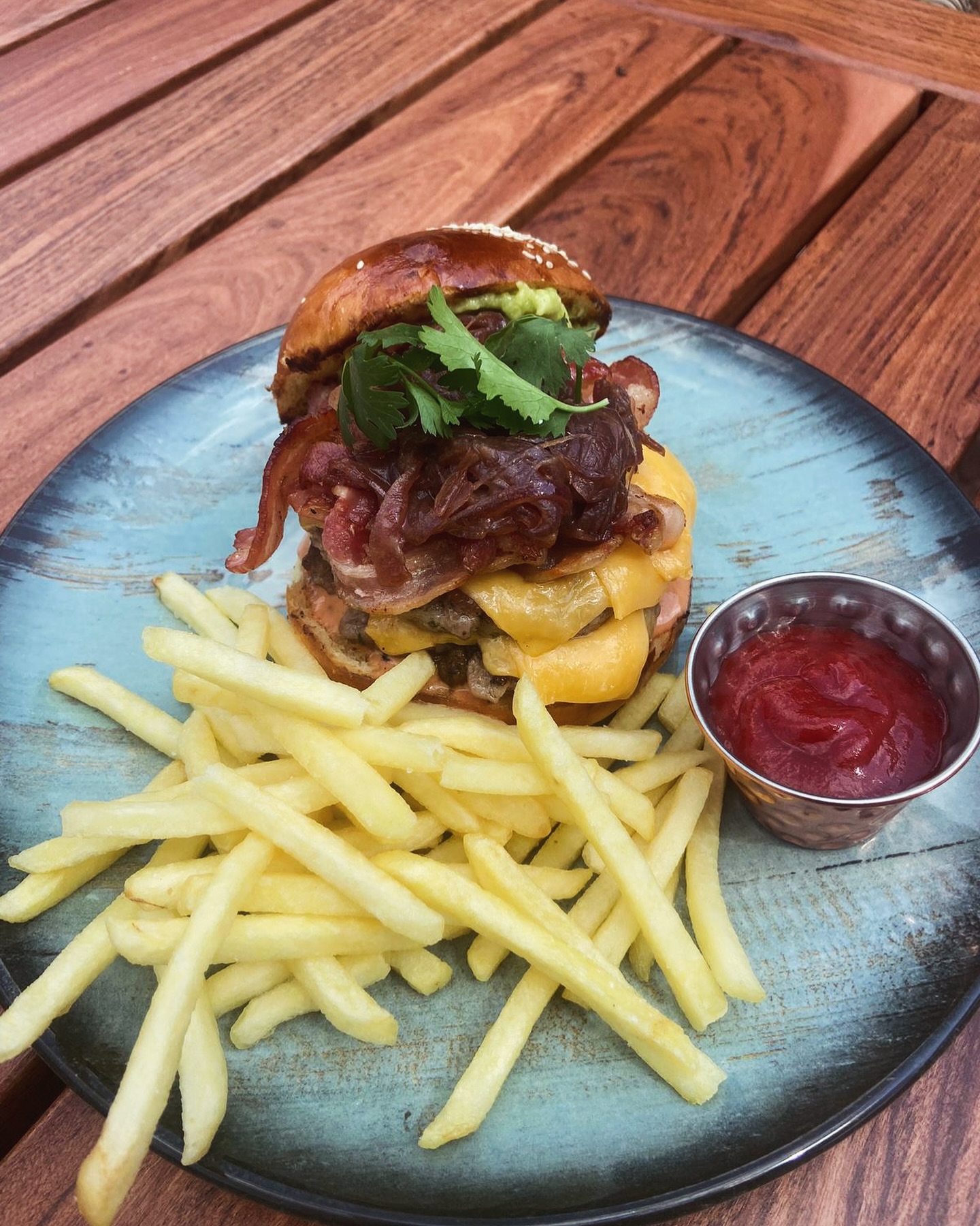 Gourmet burger with fries on Luna's outdoor deck