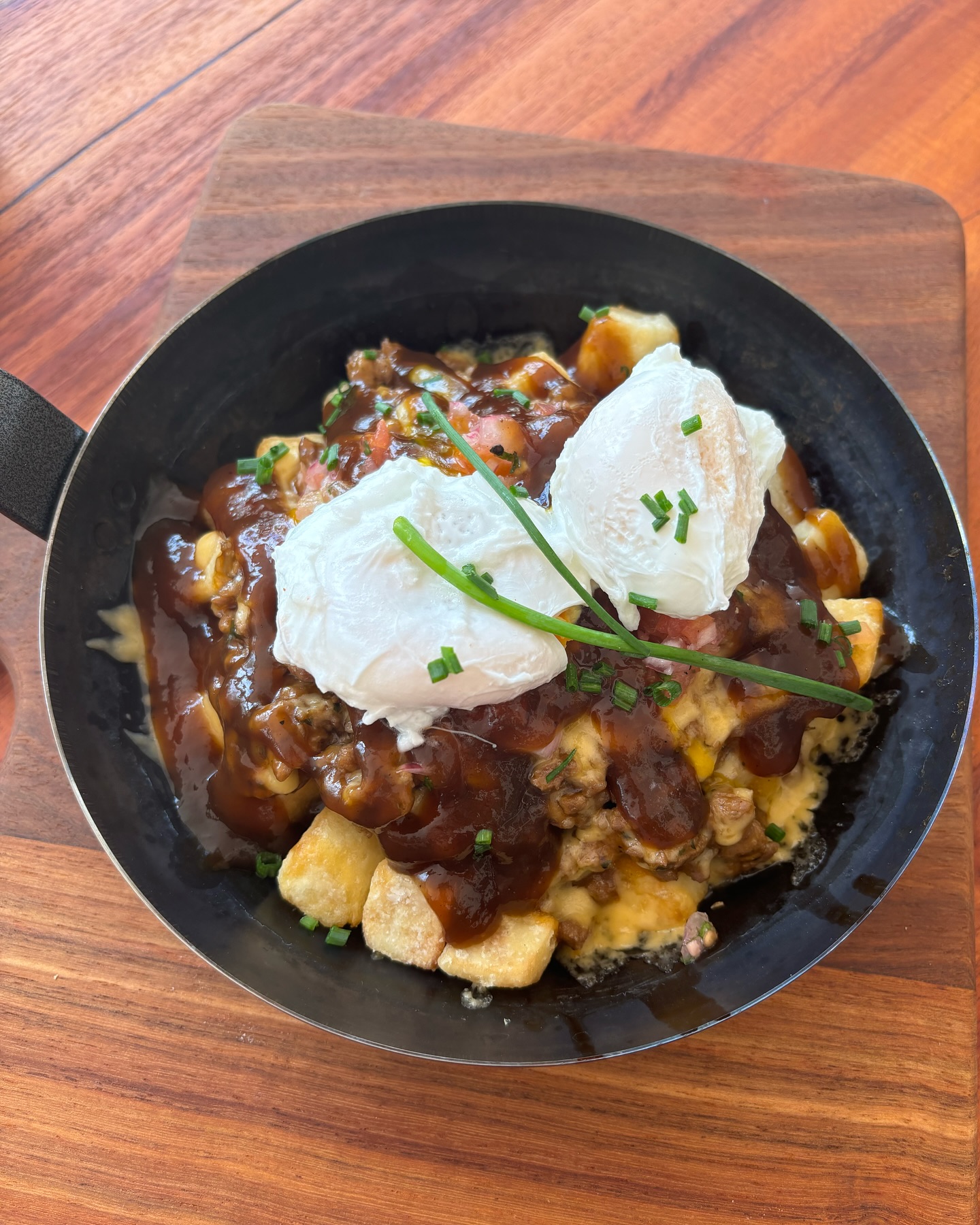 Cast-iron skillet brunch with poached eggs at Luna's