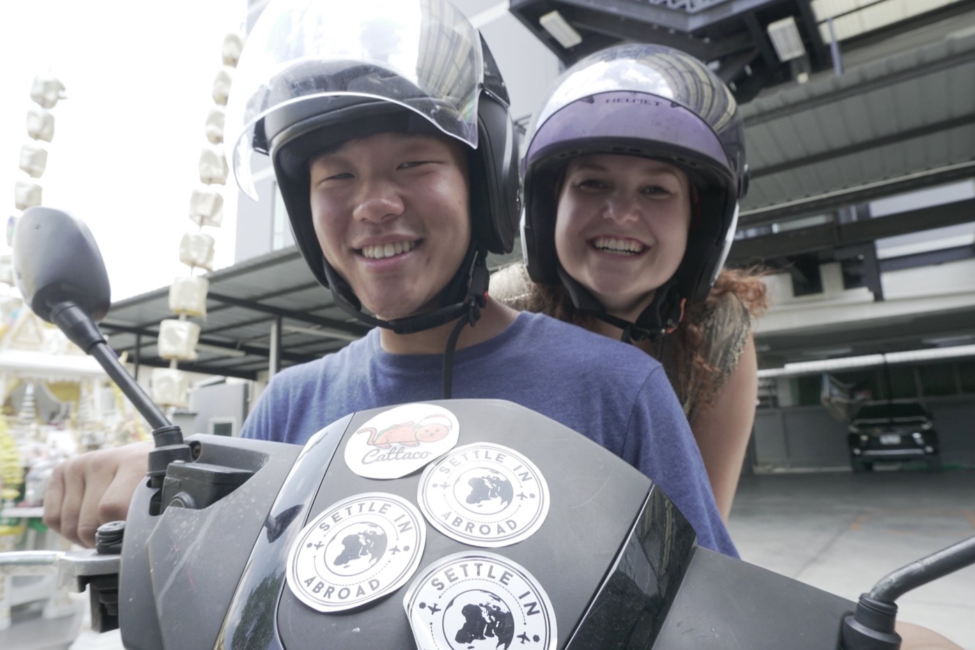 Settle in Abroad team on a scooter in Thailand