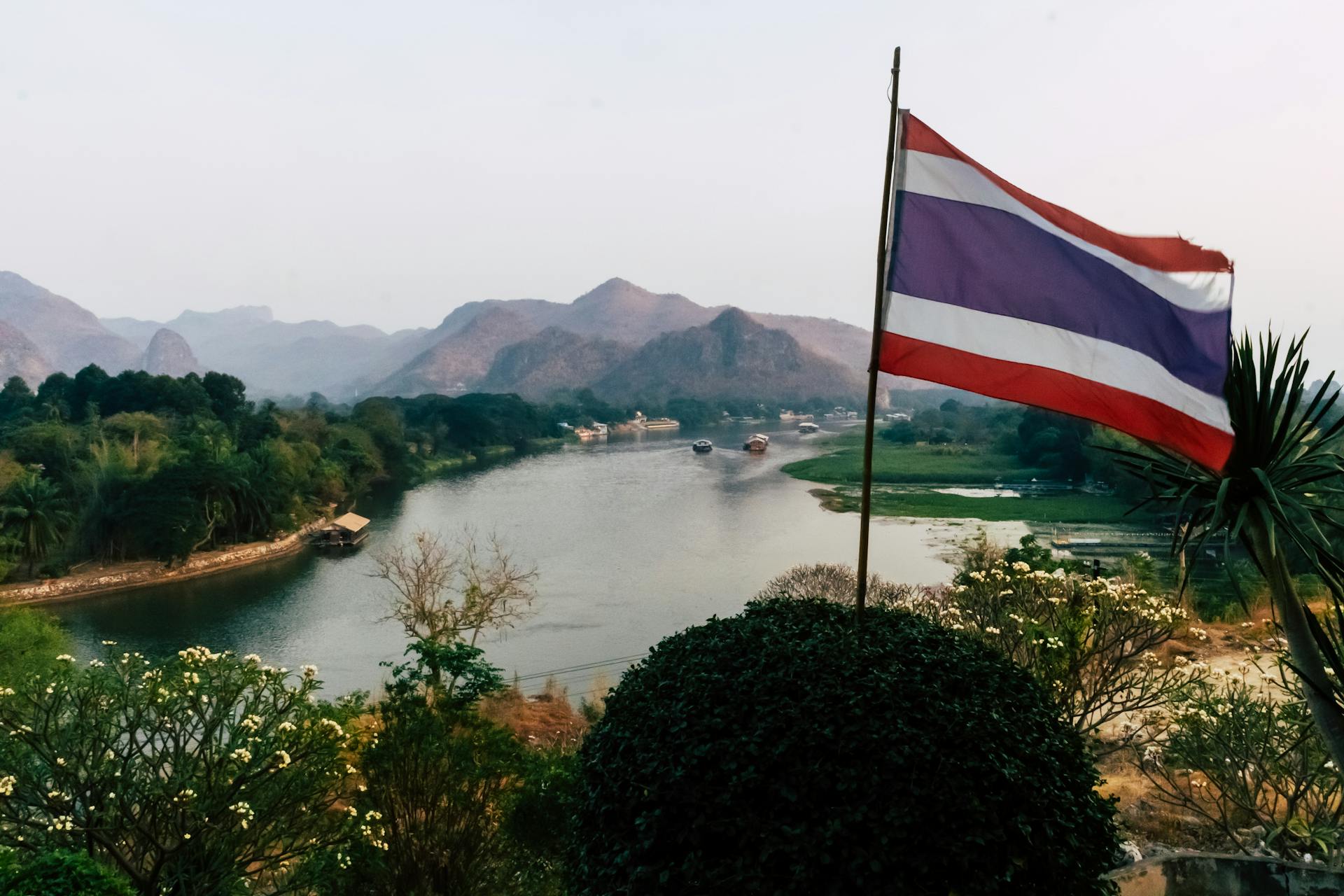 Thailand flag over a river valley in northern Thailand